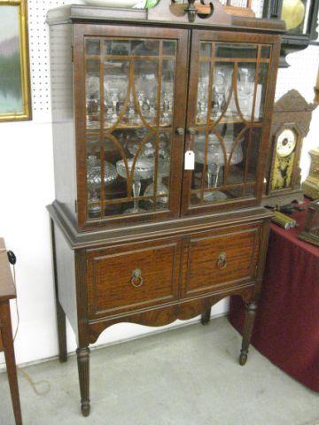 Appraisal: Mahogany China Cabinet shelves above doors below lion ring pulls