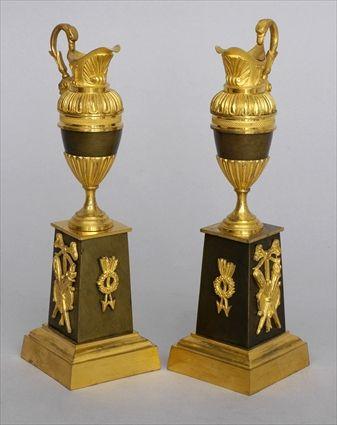 Appraisal: PAIR OF EMPIRE-STYLE BRONZE AND GILT BRONZE SMALL EWERS Each