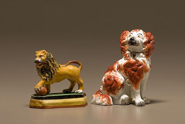 Appraisal: STAFFORDSHIRE LION AND SPANIEL FIGURES English th century A Staffordshire