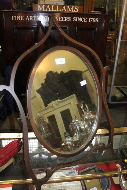 Appraisal: AN EDWARDIAN WALNUT TOILET MIRROR of oval form with shaped