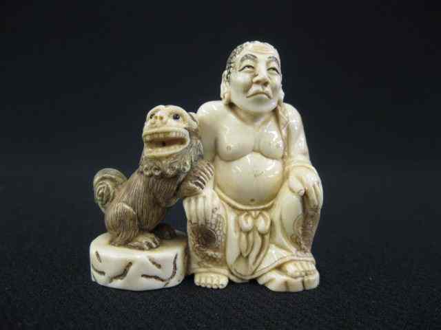 Appraisal: Carved Ivory Netsuke of a Seated Lohan with foo dog