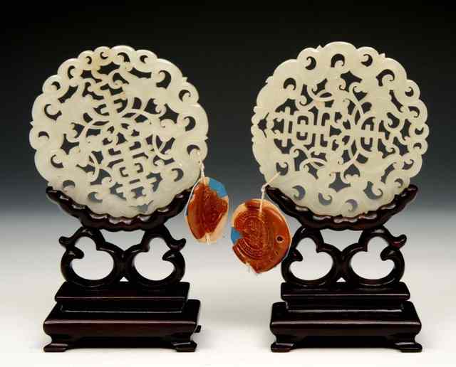 Appraisal: A PAIR OF CHINESE MUTTON FAT JADE MEDALLION SHAPED PENDANTS