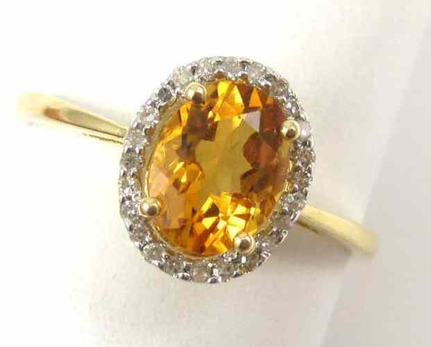 Appraisal: CITRINE DIAMOND AND FOURTEEN KARAT GOLD RING set with round-cut