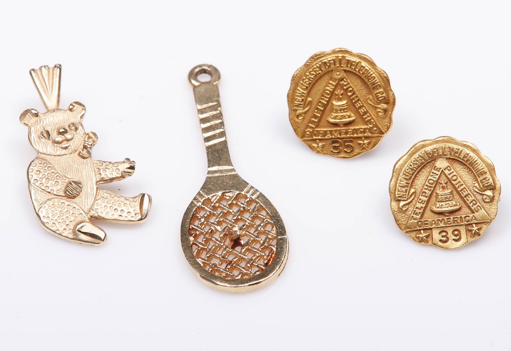 Appraisal: K and K pins and charms to include telephone pioneers