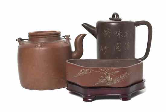 Appraisal: A Group of Yixing Pottery Teapots comprising two teapots one