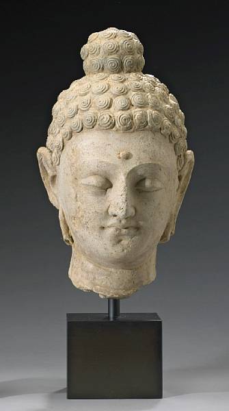 Appraisal: A large Gandharan stucco head of Buddha th th Century