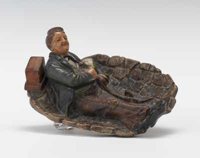 Appraisal: Johann Maresch Figural Pipe Rest Terracotta figural plate with resting