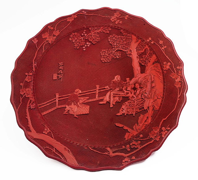 Appraisal: A large Chinese cinnabar lacquer charger th Centuryfigures on a