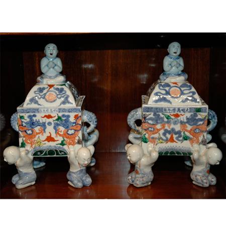 Appraisal: Pair of Wucai Porcelain Censers with Boy-Form Supports Estimate -