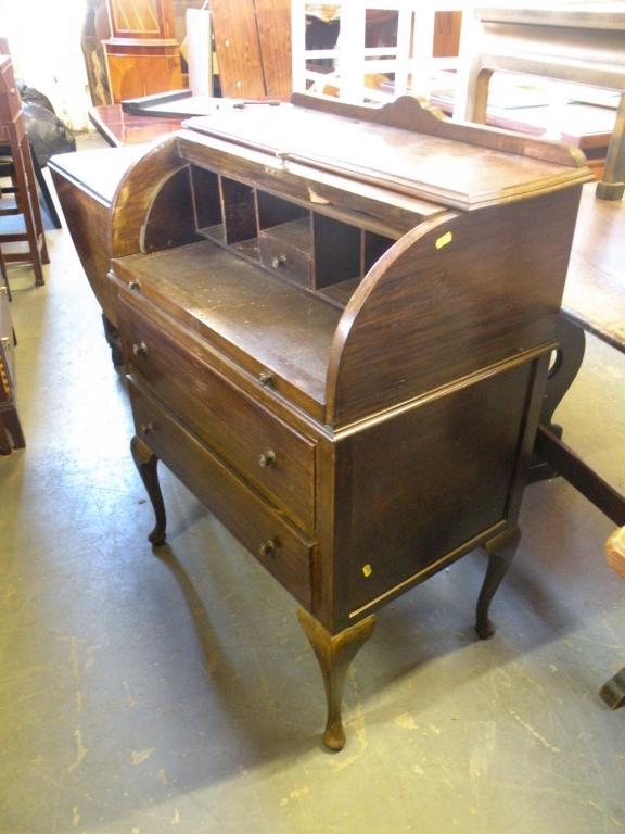 Appraisal: An oak cylinder bureau with two drawer on cabriole legs