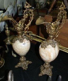 Appraisal: A pair of polished stone and brass mounted decorative jugs