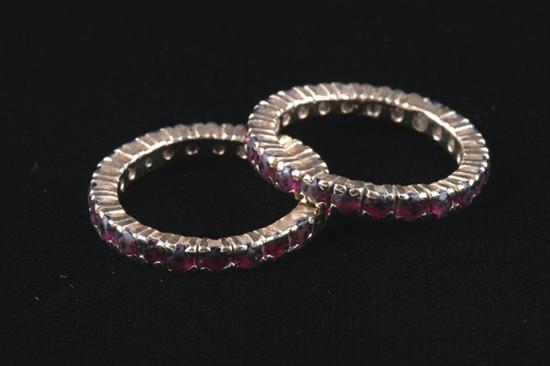 Appraisal: PAIR YELLOW GOLD AND RUBY GUARD RINGS Each has circle