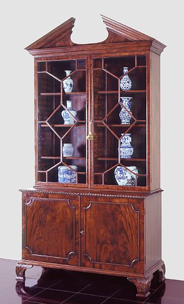 Appraisal: A George III style mahogany bookcase cabinet The architectural cornice