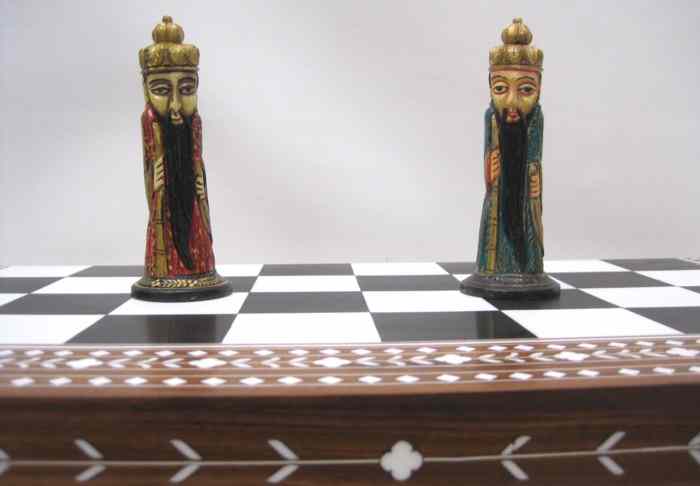 Appraisal: HAND CARVED BONE CHESS SET WITH BOARD enameled red and