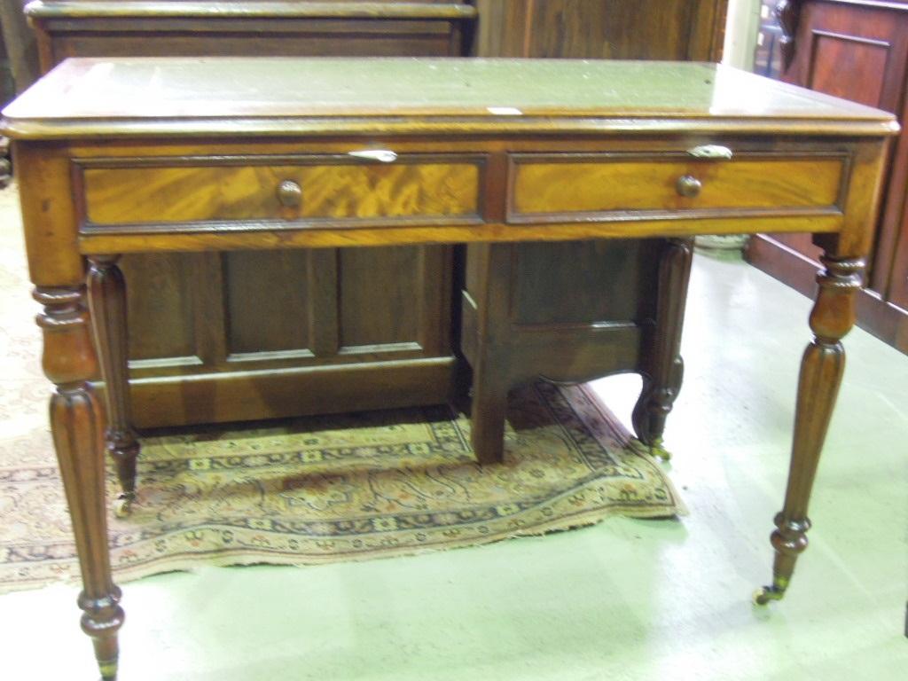 Appraisal: A Victorian mahogany writing table with inset leather top over