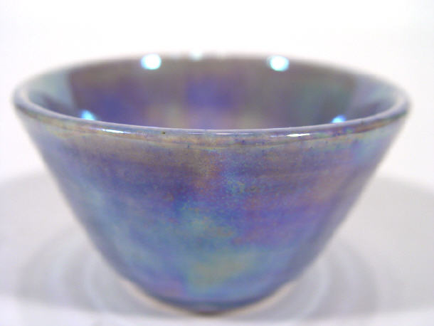 Appraisal: Ruskin pottery bowl decorated in a purple lustre glaze impressed