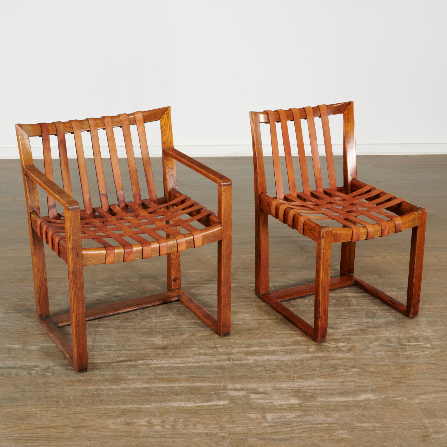 Appraisal: HERMANN HERREY OAK AND LEATHER CHAIRS c Germany wood frame