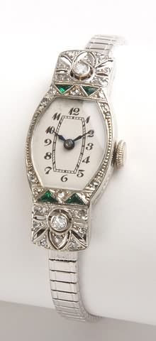 Appraisal: KW Art Deco case with trillion shaped emeralds and round