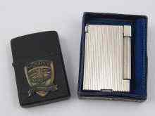 Appraisal: A black Zippo lighter commemorating the th anniversary of D-Day