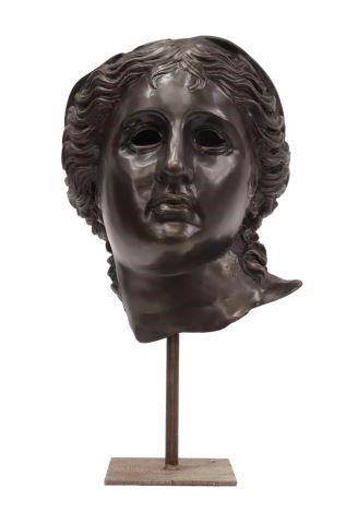 Appraisal: Decorative patinated metal mask on iron display stand after the