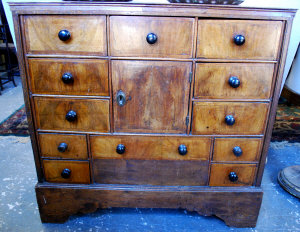 Appraisal: An early th century walnut and feather-banded cabinet with central