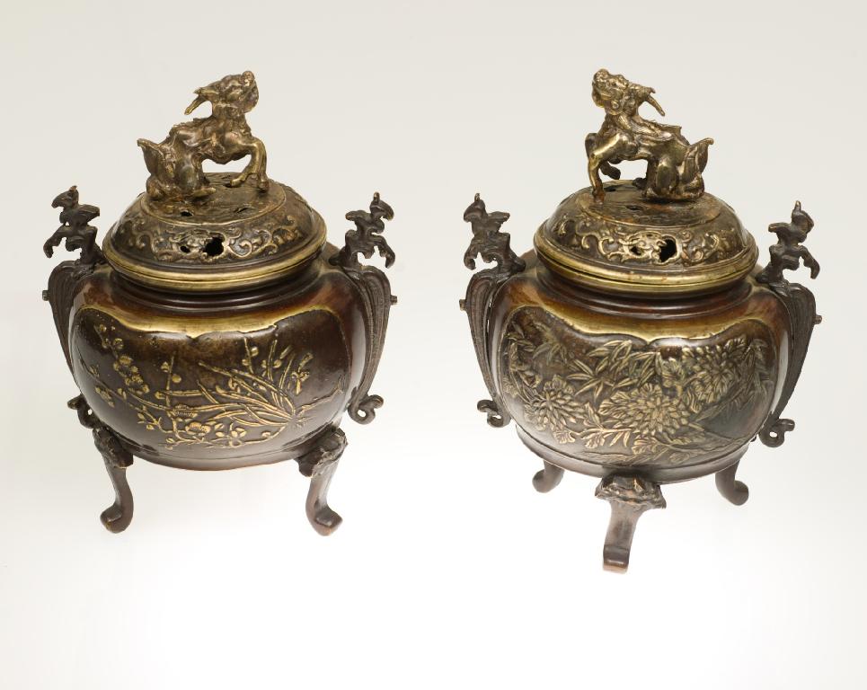 Appraisal: PAIR OF JAPANESE BRONZE TRIPOD CENSERS MEIJI PERIOD of globular