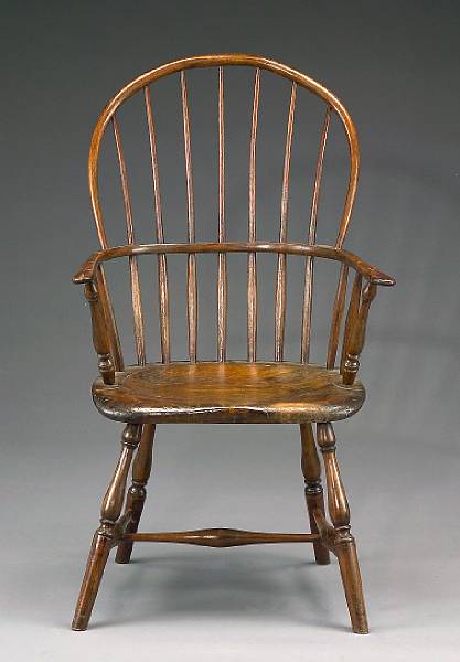 Appraisal: A mixed wood sack back Windsor chair late th century