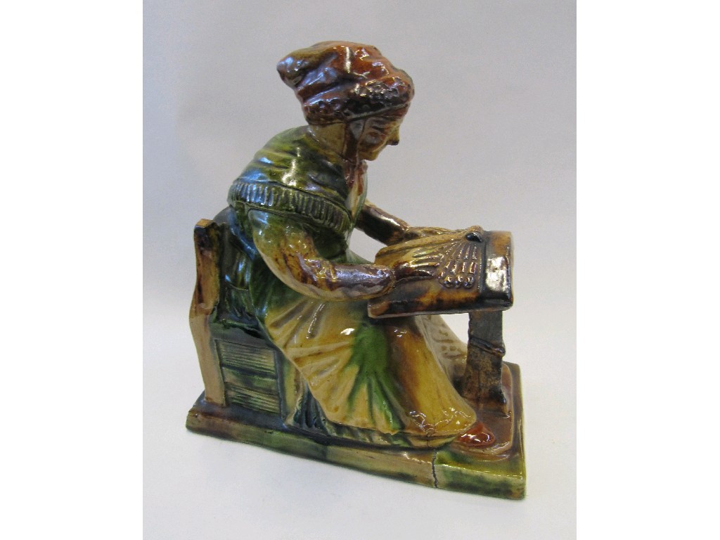 Appraisal: Continental glazed pottery figure of a lady seated at a