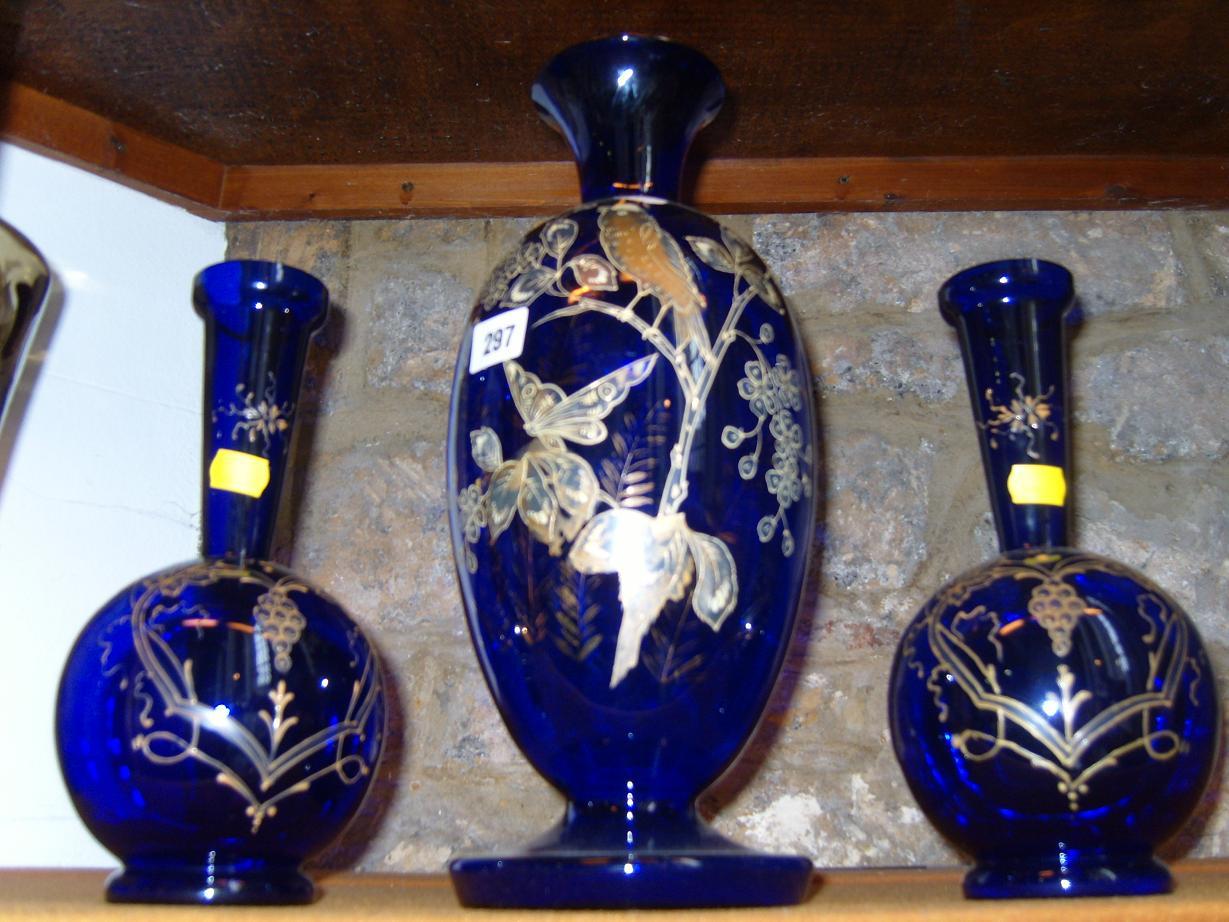 Appraisal: A garniture of three th century blue glass vases comprising