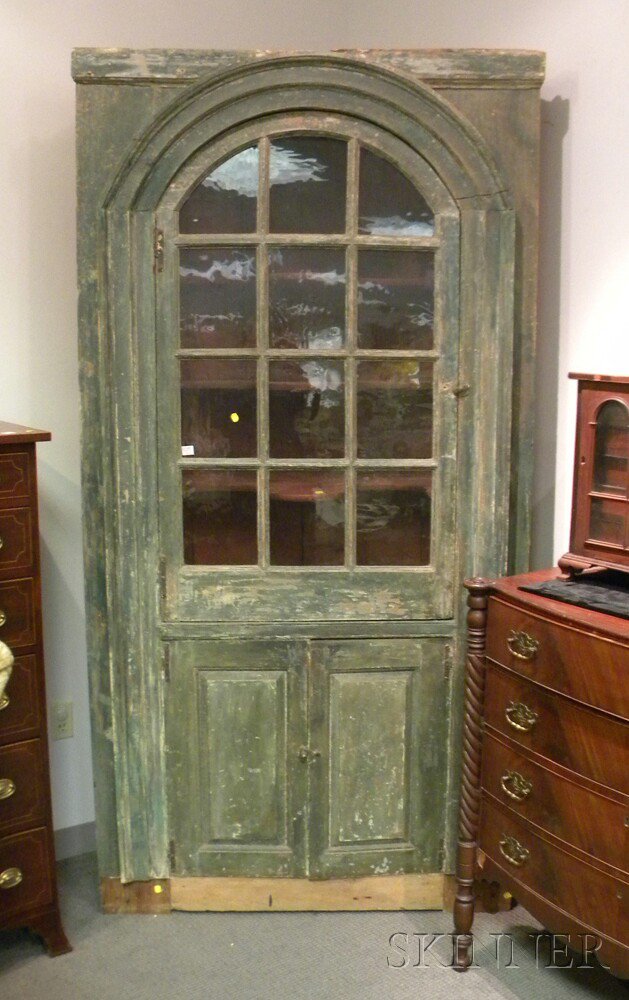 Appraisal: Green-painted Country Glazed Corner Cupboard America th century the arched