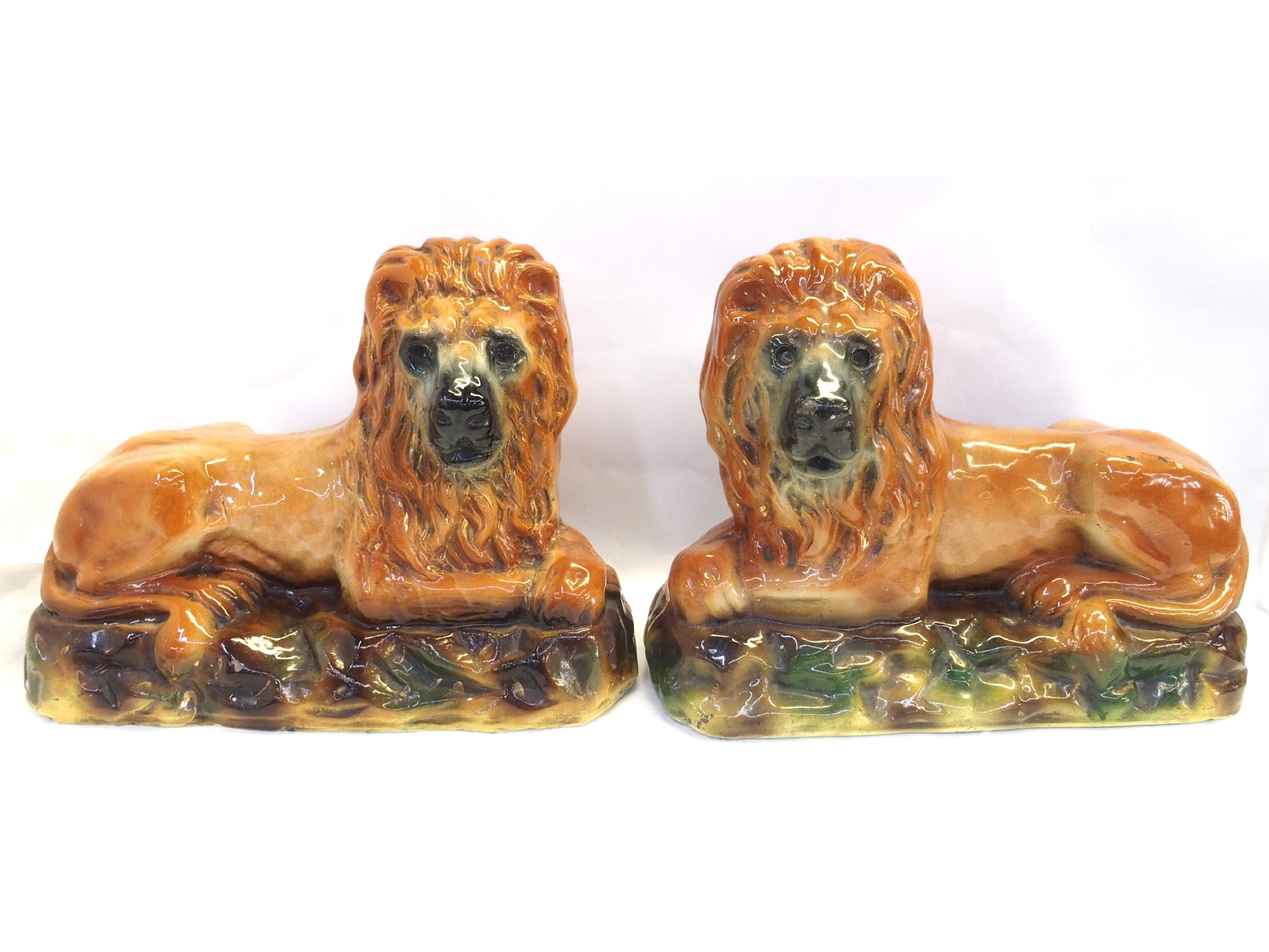 Appraisal: Pair of recumbent pottery lions