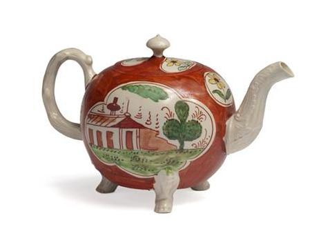 Appraisal: STAFFORDSHIRE SALTGLAZE ENAMELLED IRON-RED-GROUND TEAPOT AND COVER CIRCA Of spherical