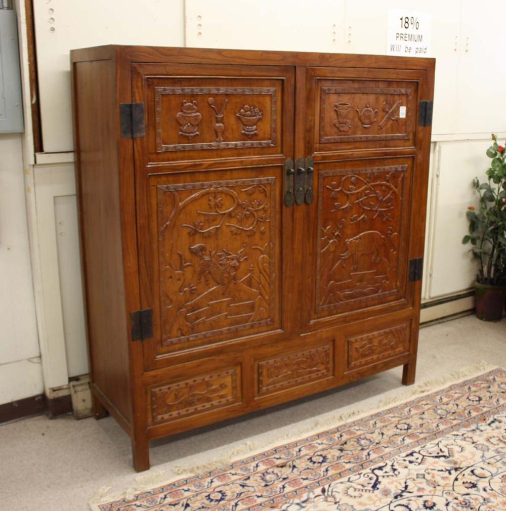 Appraisal: RELIEF-CARVED MING STYLE DOUBLE-DOOR CABINET Chinese th century the front