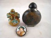 Appraisal: A mottled green jade snuff bottle with carved animal heads