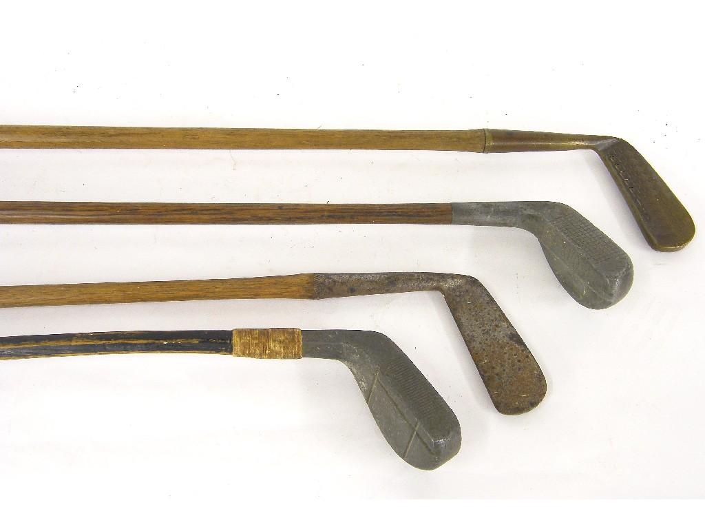 Appraisal: Four various antique golf clubs with hickory shafts