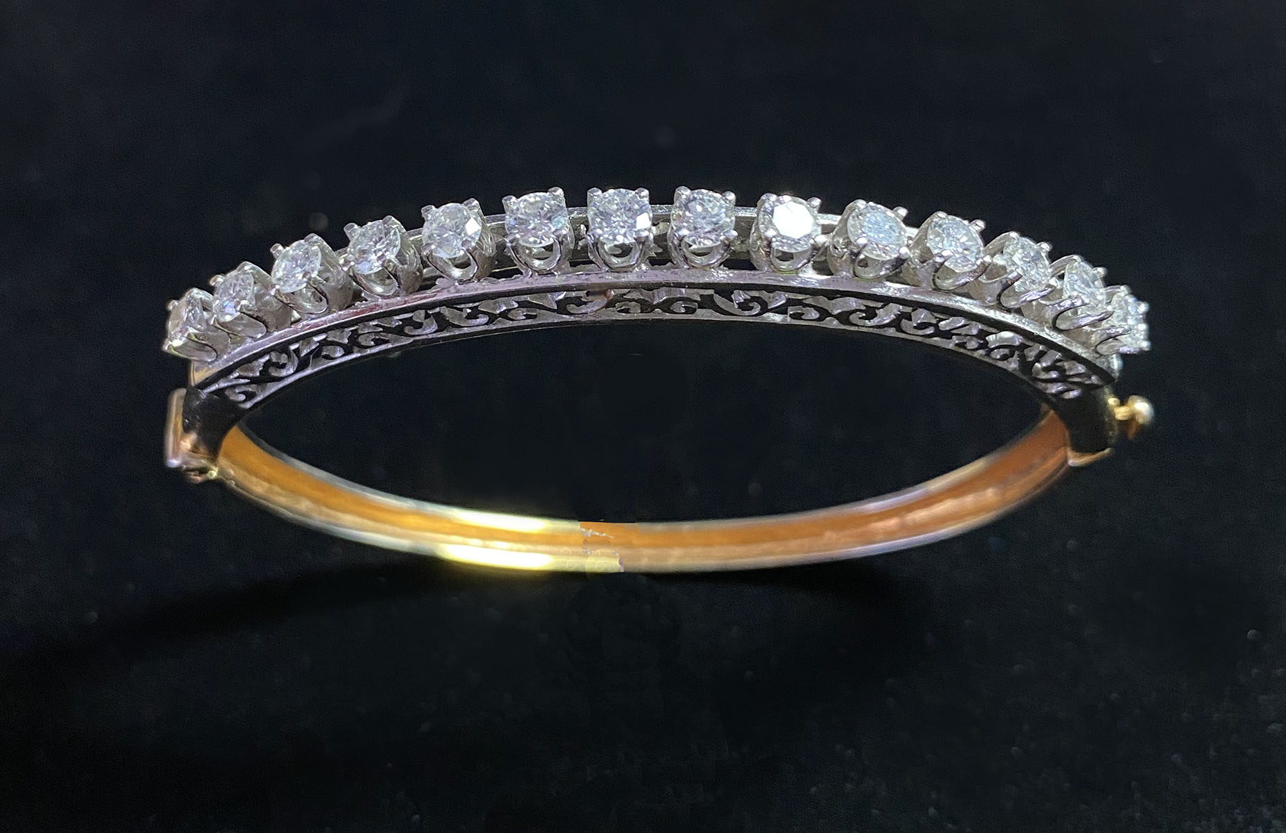 Appraisal: K YELLOW AND WHITE GOLD DIAMOND SET BANGLE An elegant