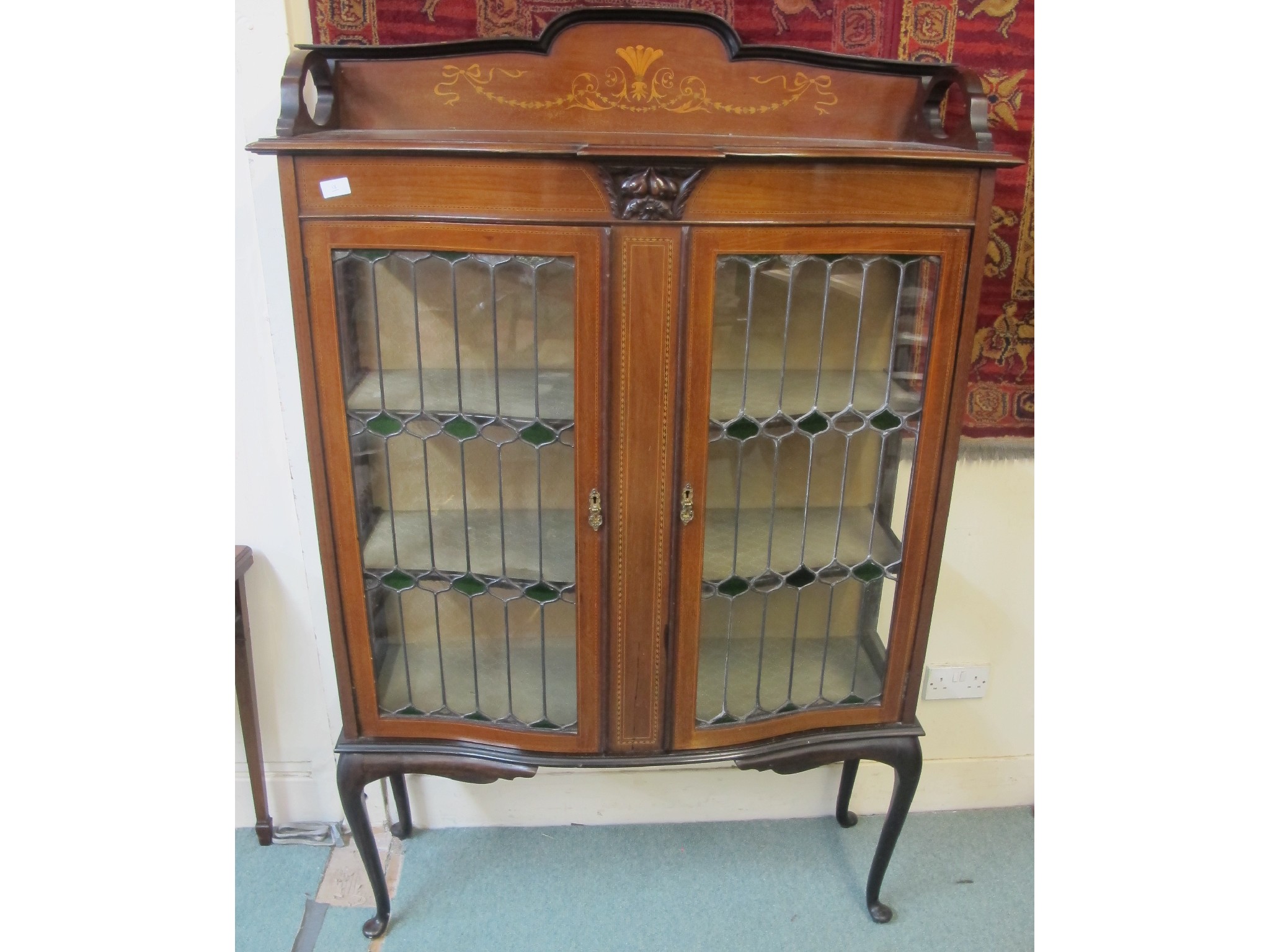 Appraisal: An inlaid mahogany large Art Nouveau display cabinet with leaded