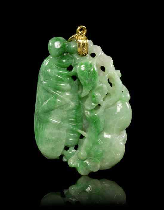 Appraisal: A Carved Jadeite Pendant of green and white colored stone