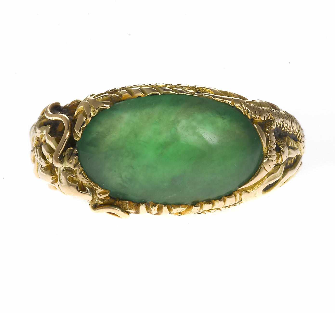 Appraisal: A jadeite jade dragon motif ring oval-shaped jadeite jade cabochon