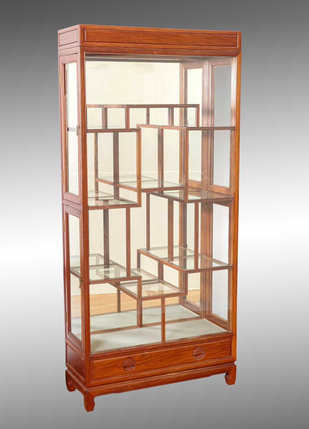 Appraisal: CHINESE STYLE LIGHTED DISPLAY CABINET off-set glass shelf cabinet having