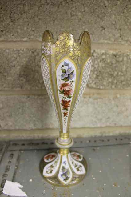 Appraisal: A BOHEMIAN OVERLAID GLASS TAPERING VASE with alternate panels of