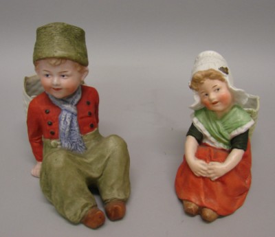 Appraisal: -Heubach sitting Dutch figurines Both are marked with sunburst symbol