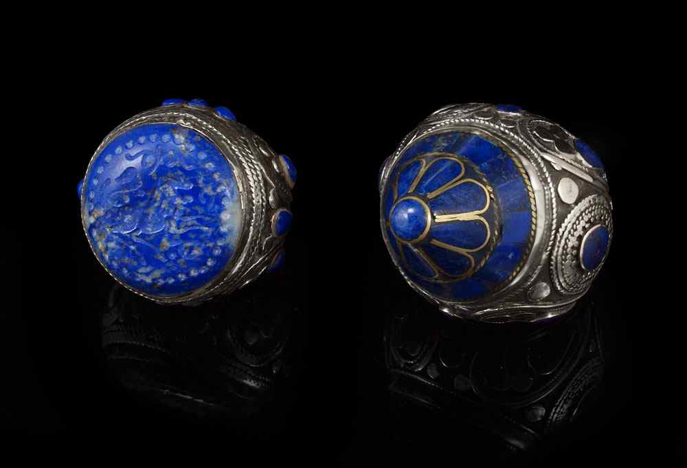 Appraisal: SILVER GEMSTONE SULTAN RINGS Sodalite intaglio carved with roaring lion