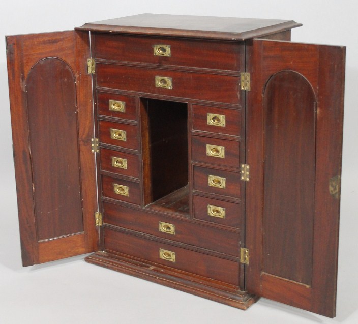 Appraisal: A thC mahogany campaign table cabinet the overhanging moulded top