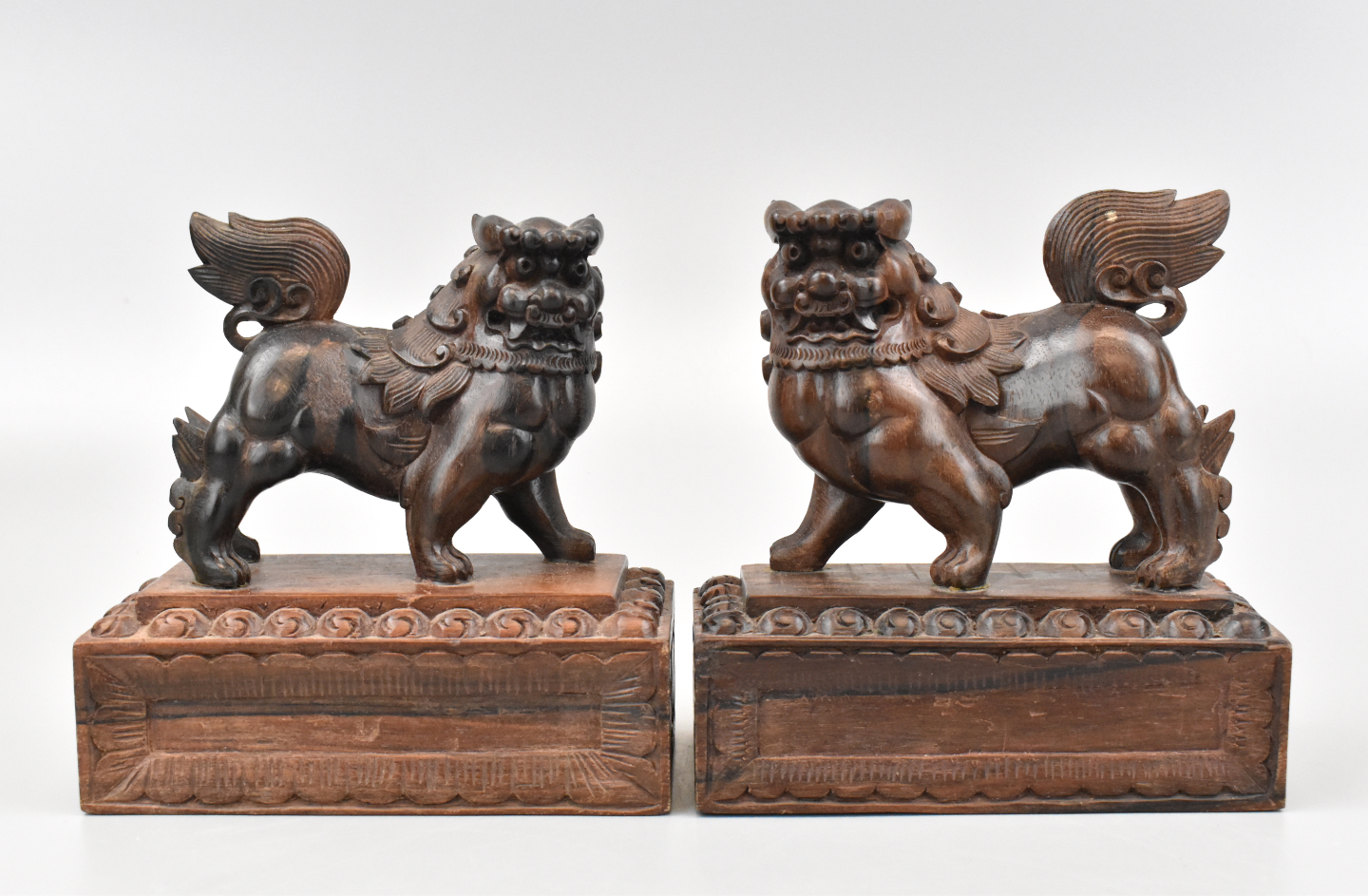 Appraisal: A pair of Chinese wood carved foo lions on carved