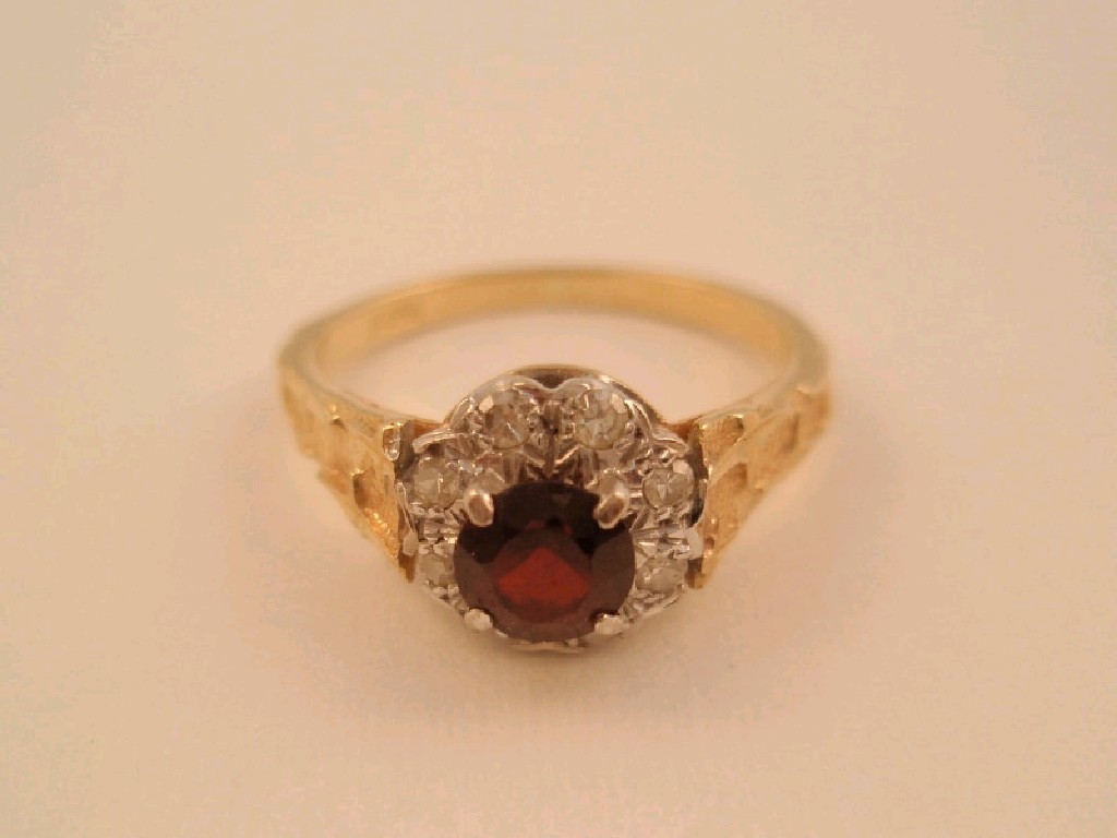 Appraisal: A garnet and white stone cluster ring to yellow shank