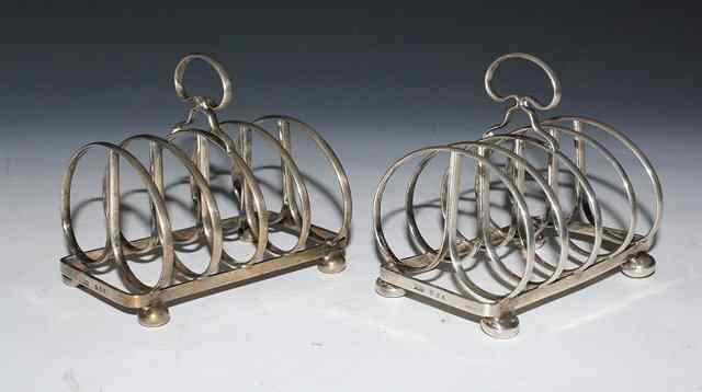 Appraisal: A PAIR OF FOUR DIVISIONAL DOUBLE HOOPED SILVER TOAST RACKS