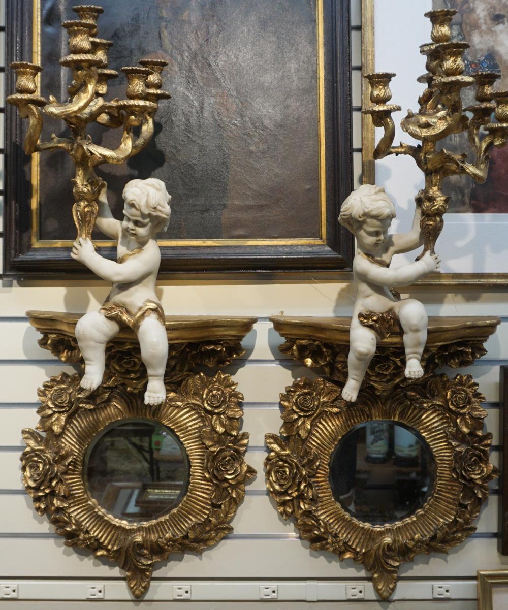 Appraisal: PAIR GILT COMPOSITION PUTTO MIRRORED CANDELABRA SCONCES APPROX H IN