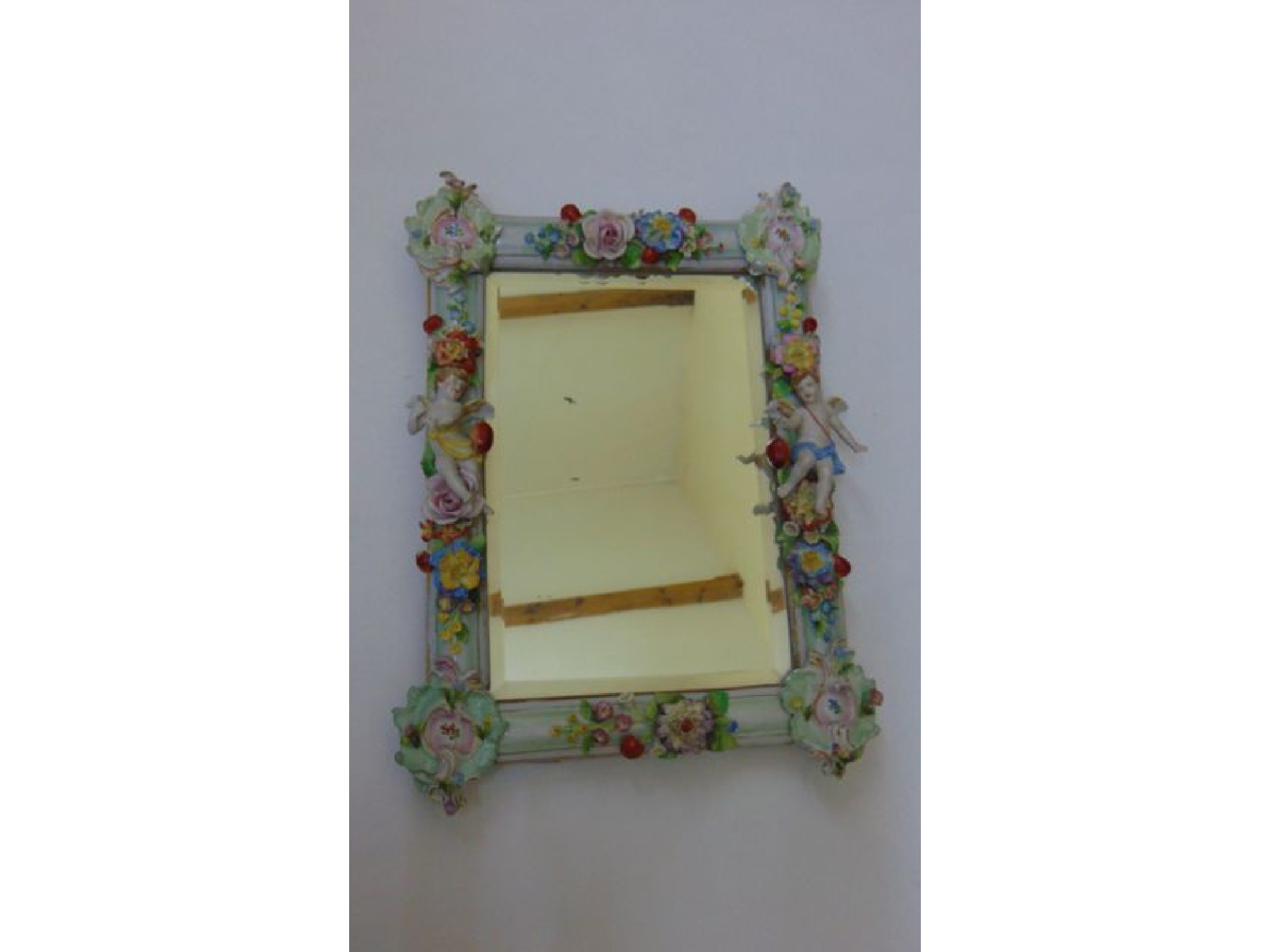 Appraisal: A th century porcelain wall mirror of rectangular form the