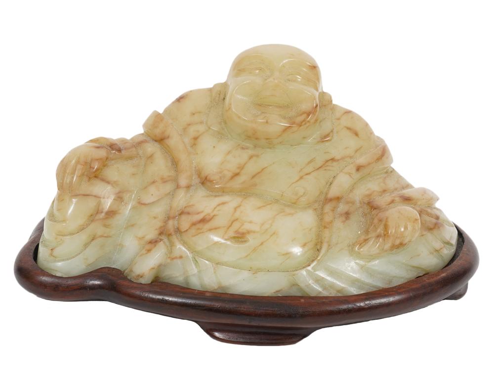 Appraisal: JADE 'HAPPY' BUDDHA ON CARVED WOOD BASEJade 'Happy' buddha sits